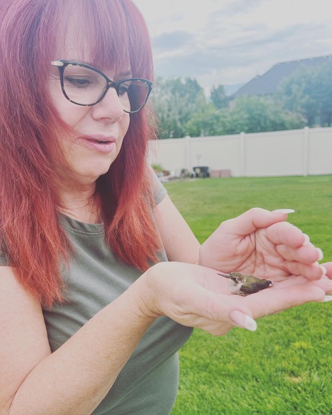 Autumn holding a hummingbird